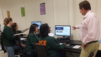 Access2online coordinator Peter Shikli with four analysts working on tasks