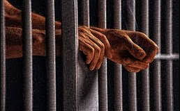 Hands reaching out of prison bars